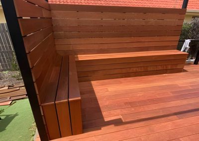 Timber deck with a built-in timber bench seat and slatted screen
