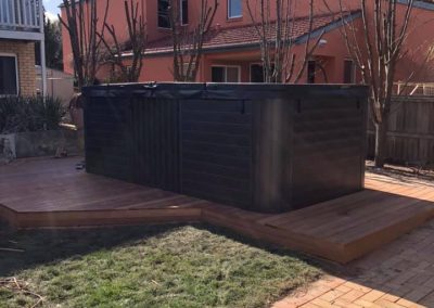 Spa sitting on a timber deck platform in a backyard
