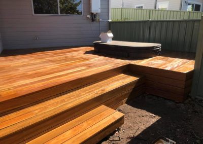 Timber deck with wide steps and a spa set into the deck