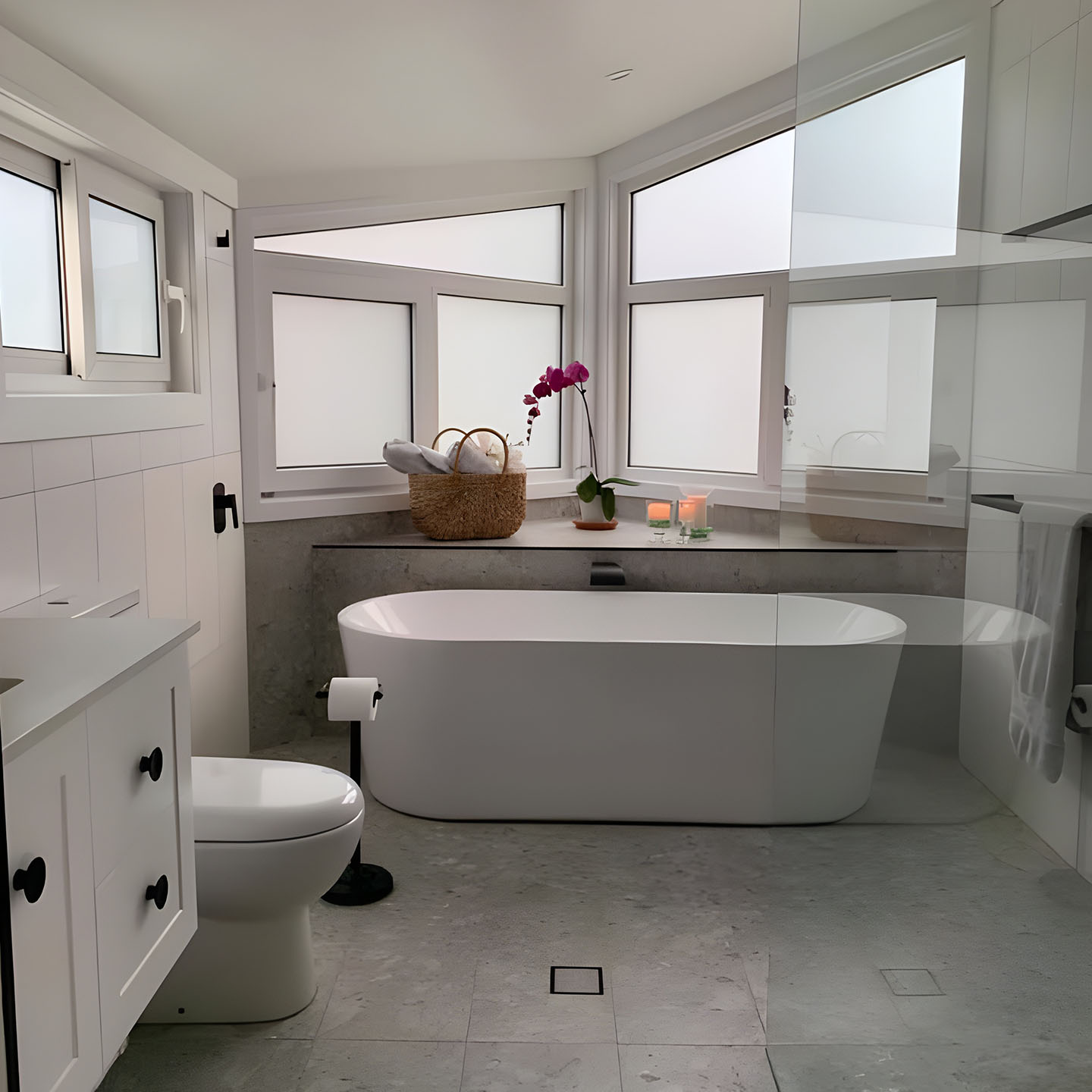 Bathroom with freestanding bath, frosted corner windows and toilet