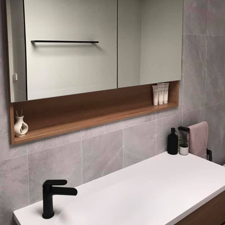 Bathroom with mirrored wall cabinet, timber shelf and black basin mixer