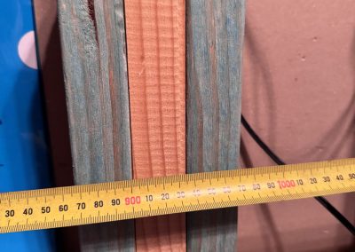 Tape measure across timber packers fixed to the wall framing