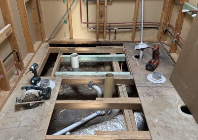 Bathroom stripped to the frame with the floor opened up to the joists