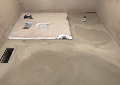 Screed laid across the bathroom floor with drains set in, ready for tiling