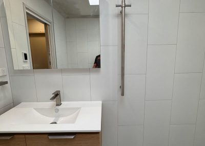 Timber vanity with white basin top and mirror cabinet, viewed straight on