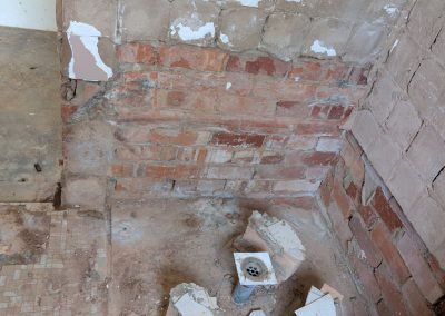 Old shower tiles and wall lining removed down to the brickwork