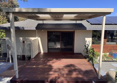 Timber deck with a pergola over it at the back of a house